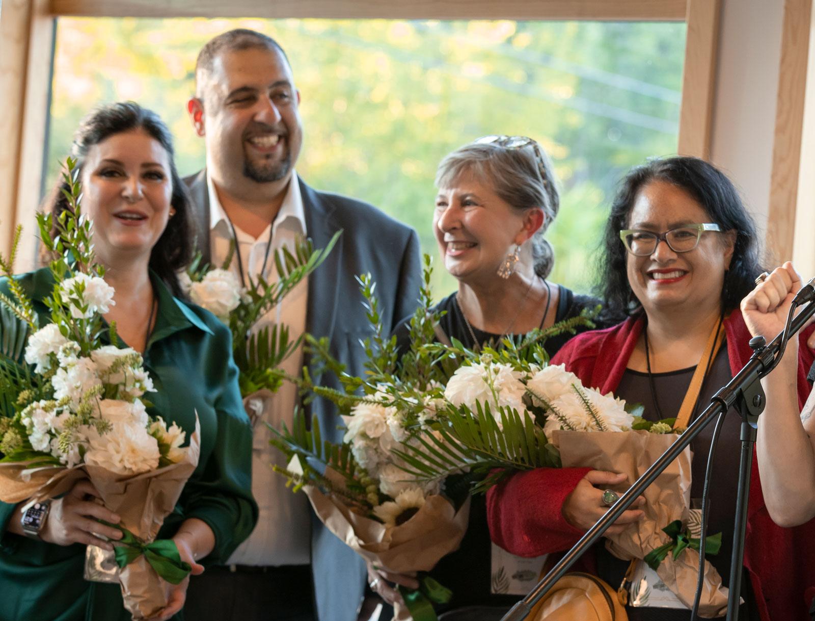 portland business leaders holding bouquets of flowers